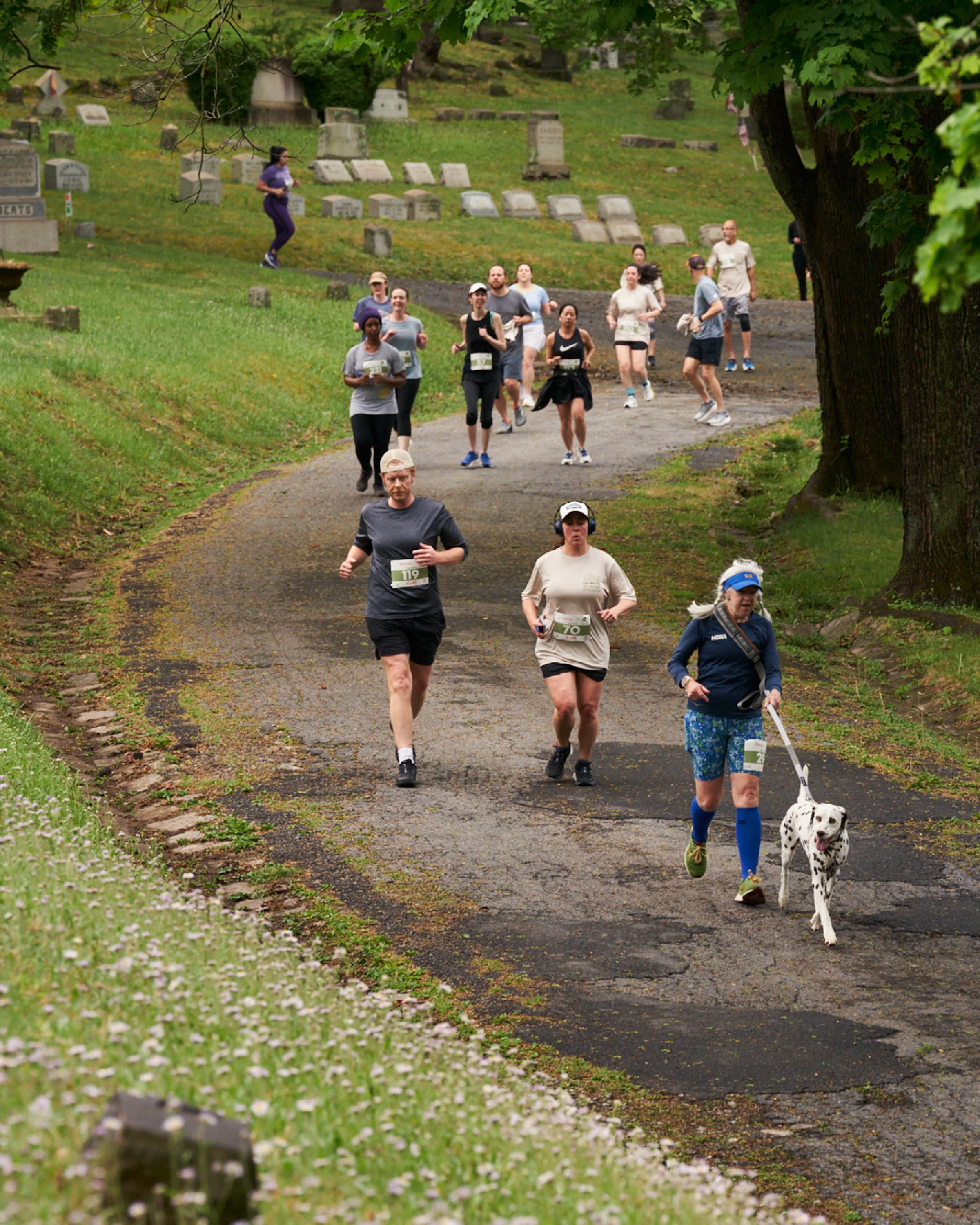 a group of runners running through the cemetery course